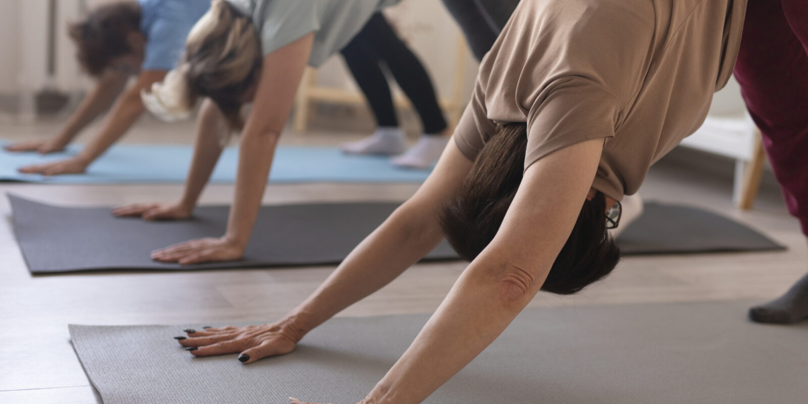 Senior women doing yoga relaxing together