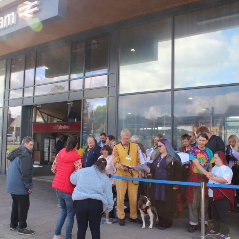 CLASP Choir singing outside Wokingham Station